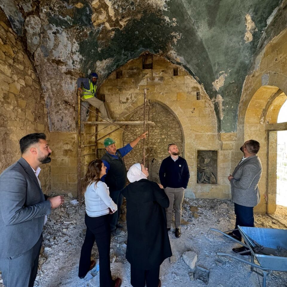 A msall group of people looking at restoration work in progress inside Bayt Al Jahgbeer in Amman, Jordan