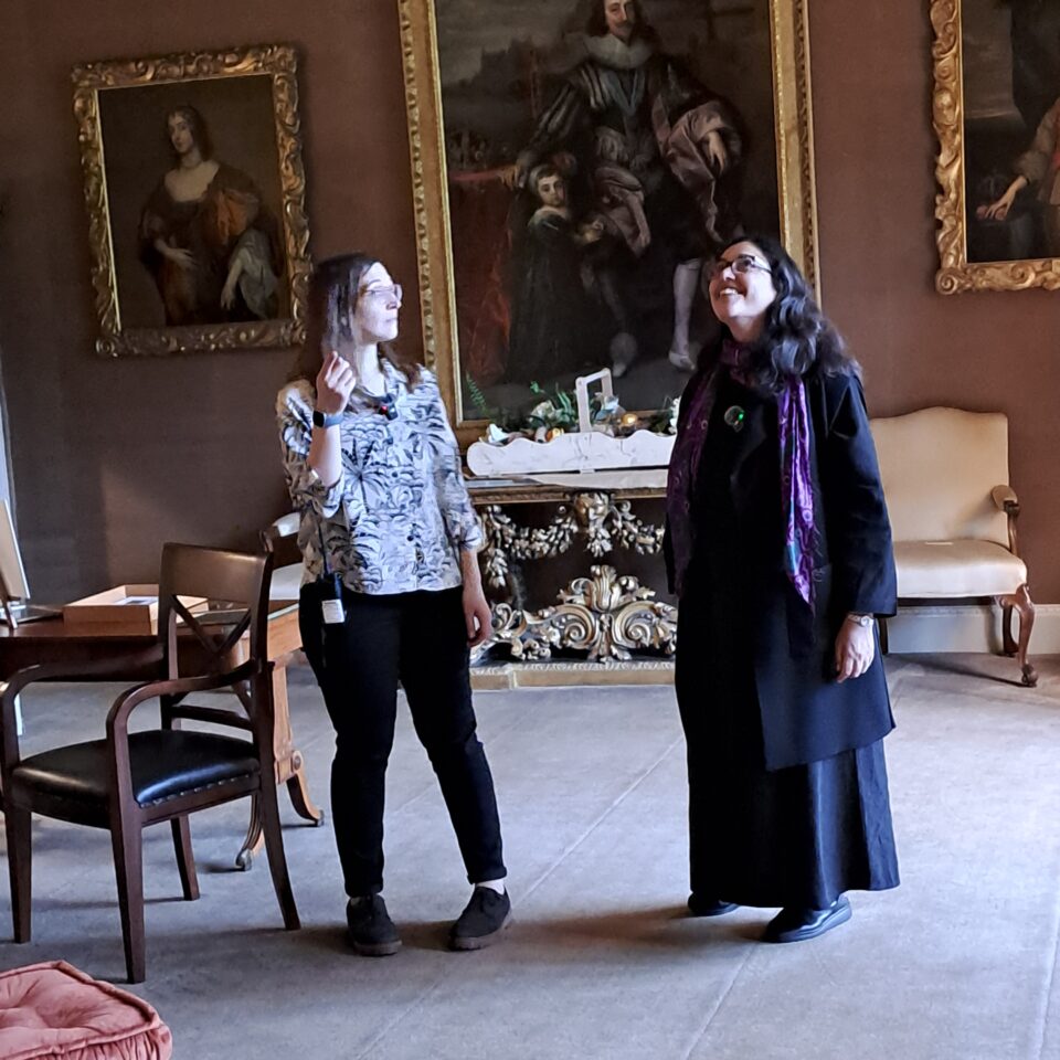 two women looking at the interior of a richly decorated room at Blickling estate