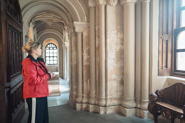 General Manager Ceri Williams points out damage from water ingress in the entrance to Penrhyn Castle. 