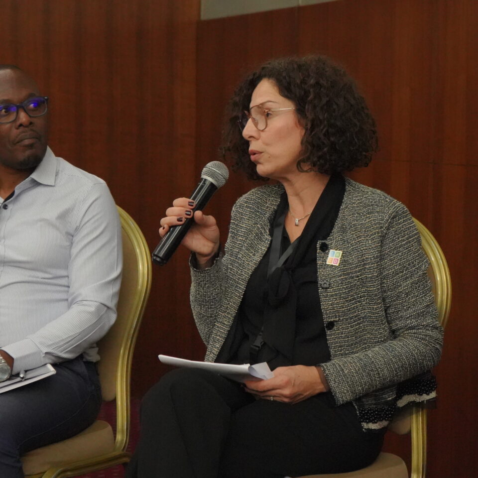 Mirna Musharbash taking part in a conference panel alongside Simon Musasizi of the Cross-Cultural Foundation of Uganda