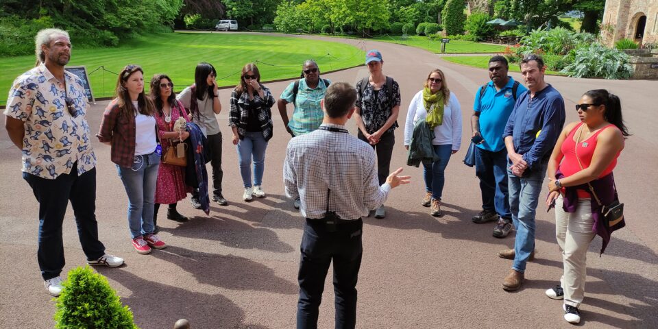 Group of people listening to someone talking about a castle